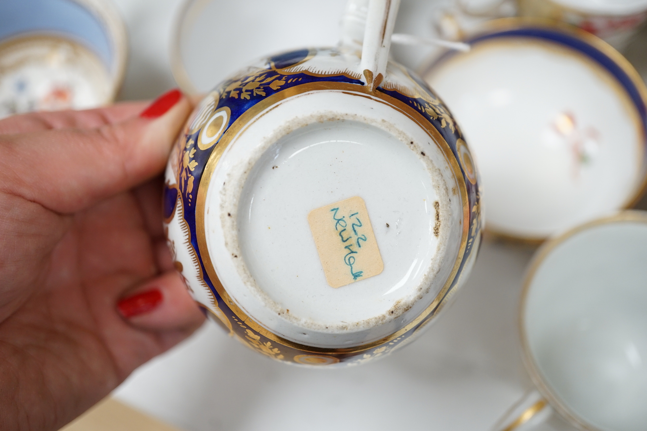 A group of Regency and Victorian porcelain tea, coffee cups and saucers, Newhall, Chamberlains, Coalport, etc.